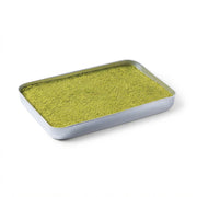 A rectangular silver metal tray filled with a fine, bright yellow-green pistachio powder, photographed on a clean white background.