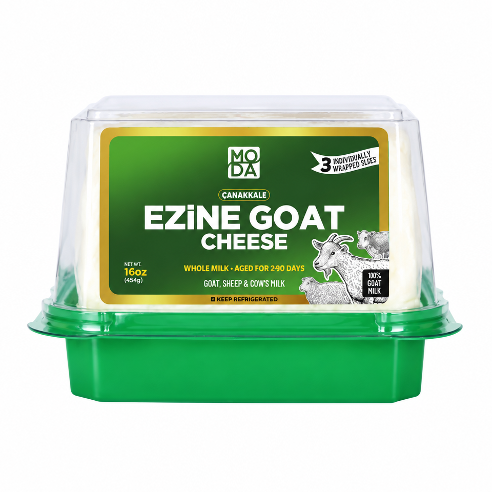 Packaged Ezine Goat Cheese in a vacuum-sealed container with a green lid, labeled with the brand MODA, product name, weight, and an illustration of goats on the front.
